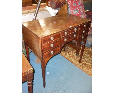 An elegant 19th c. Desk/Side Table/Dressing Table having tapering square legs, eight short drawers with drop ring handles and