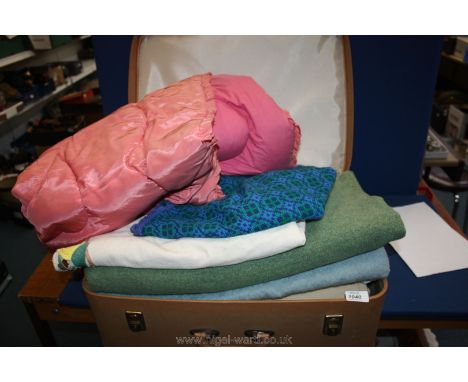 A suitcase containing an eiderdown, wool blankets, etc.