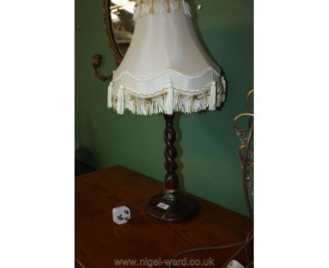 An open barley twist lamp with shade.