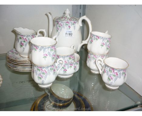 A Royal Albert rose drop coffee set including six cups and saucers, coffee pot, milk jug and sugar bowl.