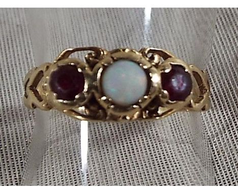 A lady's 9ct gold ring set with centre opal surrounded by two rubies, size O 1/2, approximate weight 2.19 grams