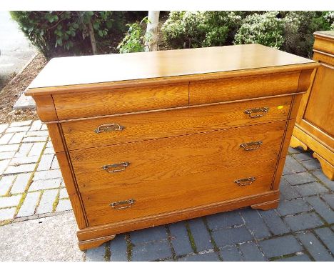 A good quality light oak chest of two over three drawers on bracket supports and brass drop handles 88.5cm x 119cm x 53cm 