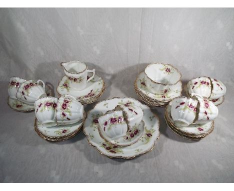 A 35 piece ceramic tea service by Wellington China J.H.C.&Co, Longton decorated with a floral pattern and gilded highlights (