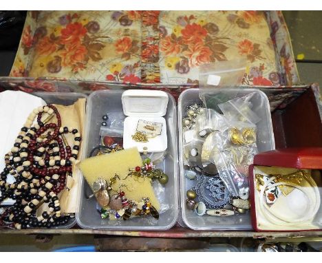 A vintage suitcase containing a quantity of costume jewellery and accessories to include enamelled pendants, paired earrings,