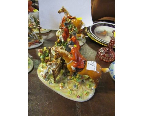 Three German porcelain fox hunting groups, of various figures in pink with horses, hounds and fox, crown and shield mark, hei