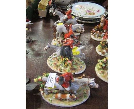 Four German porcelain fox hunting groups, of various figures in pink with horses, hounds and fox, crown and shield mark, heig
