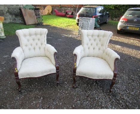A pair of deep button back armchairs