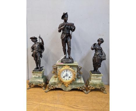 A late 19th century clock garniture surmounted by spelter figures on an onyx case and standsLocation: 