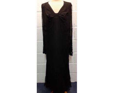 A 1920's/30's black sheer evening dress with button mesh lace to the arms and lower skirt having a separate sheer black slip,