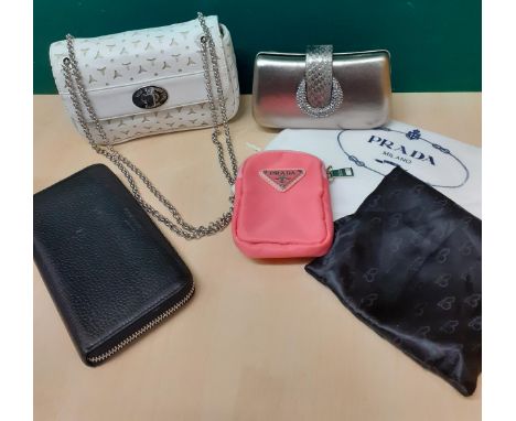 Lulu Guiness and Prada- A small Lulu white leather occasional bag having a cut-out design, silver tone hardware and chain tog