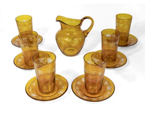 An amber glass water pitcher, six glasses and small plates