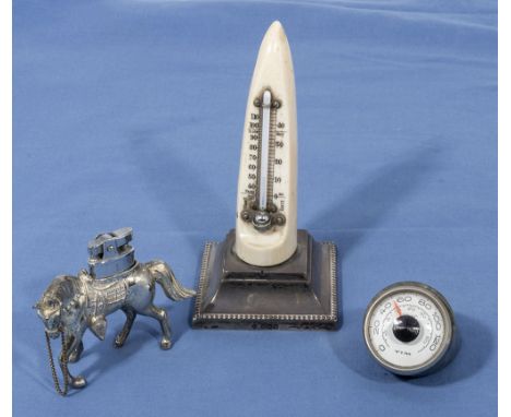 A horn thermometer, cigarette lighter and one other
