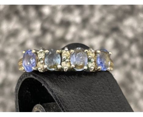 Ladies 9ct gold blue stone and Diamond ring. Featuring 4 oval blue stones and Diamonds in between. 2g size M