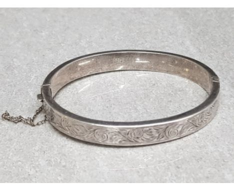 Lady's silver hinged bangle one half engraved and safety chain hallmarked Chester 13.5g.