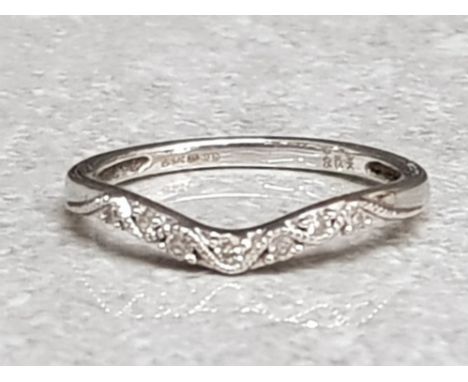 A 9ct white gold and seven diamond set band ring size K1/2 1.4g gross.