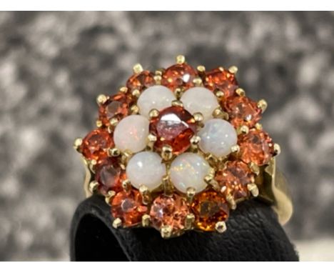 Ladies 9ct gold opal and red stone cluster ring. Set with 6 opals and 13 red stones.