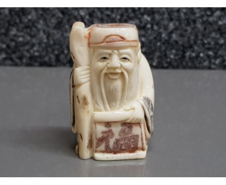 Hand carved bone netsuke, carved as an elder with staff