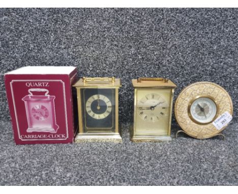 Two brass carriage clocks, one boxed, together with MCM round mantle clock.