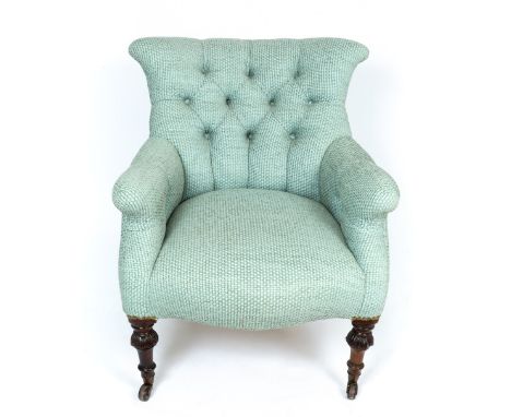 A late Victorian upholstered button back low armchair with rosewood supports terminating in brass and ceramic casters, 68cm w