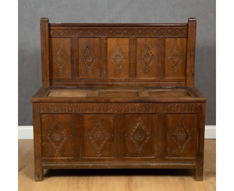 An 18th century oak and iron bound monks bench with carved panels, 116cm wide x 49cm deep x 110cm highCondition report: Surfa