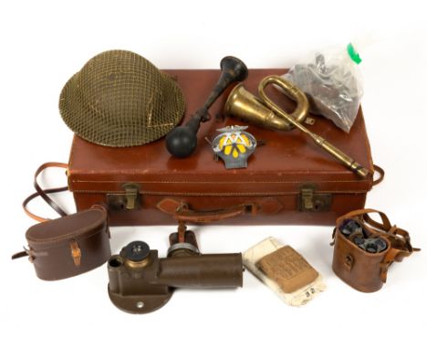 An old leather suitcase containing a World War I helmet, an old gun sight, two pairs of binoculars, two old car horns etcCond