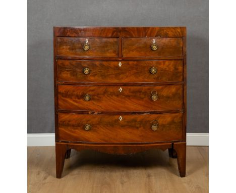 A Georgian mahogany bow front chest of two short and three long drawers with later brass ring handles and bracket feet, 102.5