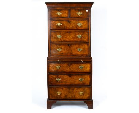 A Georgian style walnut chest on chest with two short and six long drawers with brass swan neck handles and raised on bracket