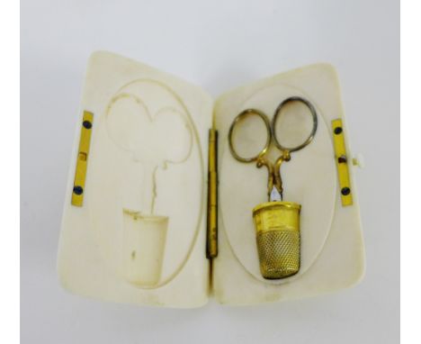 A late 19th century ivory necessaire, the hinged box housing a thimble and small scissors 9 x 6 cm 