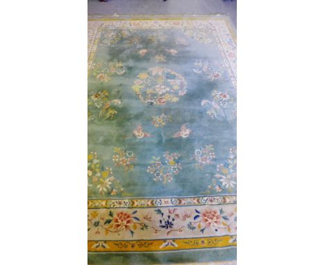 A Chinese carpet, the green field with birds and foliage design within a foliate border, 370 x 276cm