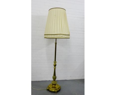 A heavy brass standard lamp and shade