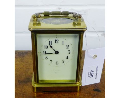 A small French brass cased carriage clock, the white enamel dial with Arabic numerals, stands at approx 14cm 