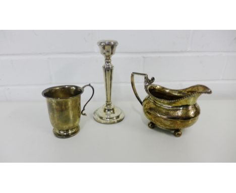 Birmingham silver christening cup, a London silver cream jug and a Birmingham silver candlestick (3) 