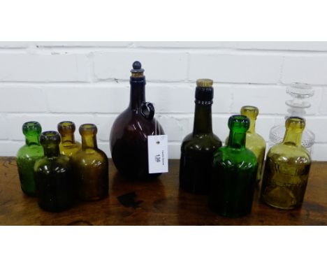 A collection of nine coloured glass bottles and a small decanter and stopper, (10) 