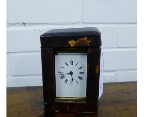 A late 19th century French brass case carriage clock, the white enamel dial with black Roman numerals , complete with leather