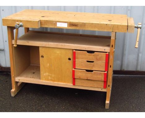 A modern Sjobergs wooden tool bench, the overhanging top with vice above open sections and drawers, 86cm high, 123cm wide, 52