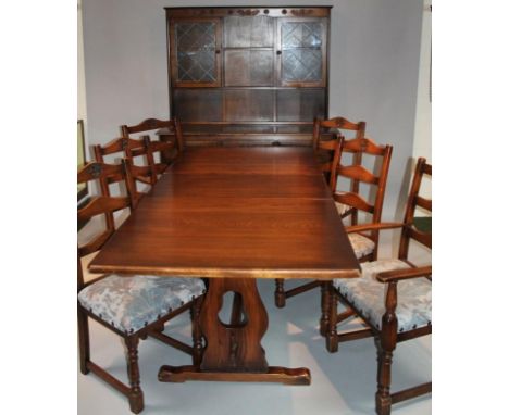 A Mellowcraft dark wood dining suite, comprising of table and a similar dresser, the upper section with open shelves flanked 