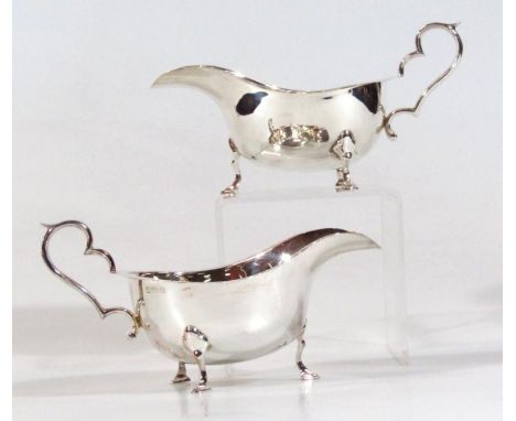 A pair of George VI silver sauce boats, each with flared outlines, ear shaped handles and triple hoof leaf capped supports, B