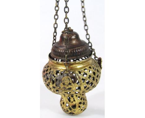 A Russian gilt metal sanctuary lamp, the heavily pierced inverted body headed by angels, pierced with flower heads and scroll