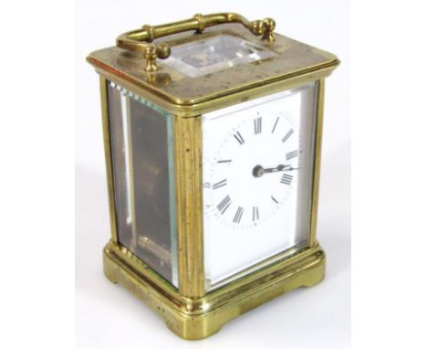 An early 20thC brass carriage clock, of small proportion, with Roman numeric dial and baton pointers, in a brass and glazed c