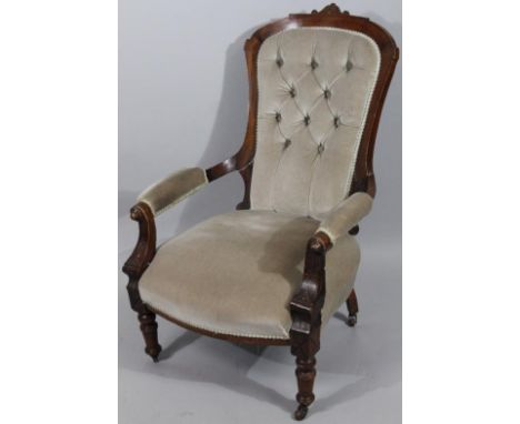 An Edwardian walnut framed armchair, with button back and shaped seat, on turned front supports with back castors, (later) pl