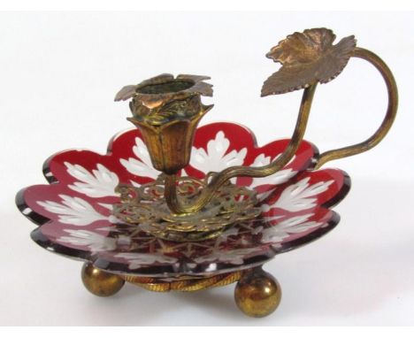 An early 20thC ruby and frosted glass gilt metal candlestick, of small proportion, with a flower head outline and entwined st