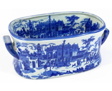 A modern Ironstone blue and white pottery foot bath planter, of oval outline, transfer printed with a figure on horseback bef
