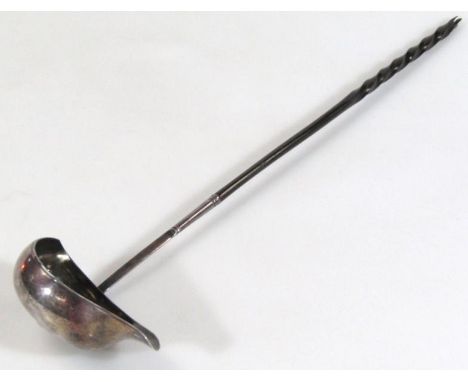 An early 19thC toddy ladle, with part turned whale bone handle and lipped bowl, unmarked white metal, 35cm high.