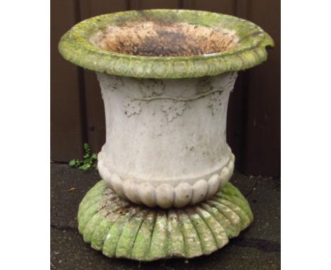 An early 19thC style concrete and stone urn planter, the bell shaped body on an elaborate floral base, 72cm high.