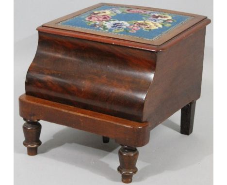 A Victorian mahogany box commode, the hinged lid with petit point floral decoration and cushion scroll base on turned front s