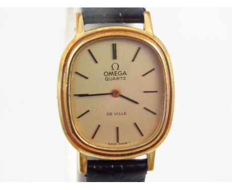A 20thC ladies Omega quartz De Ville wristwatch, the oval 2cm wide dial with baton numerals and pointers attached to a black 