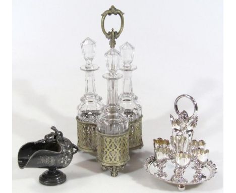 Various silver plate, etc., comprising a three bottle tantalus set with three glass decanters, 44cm high, egg cruet and a pew