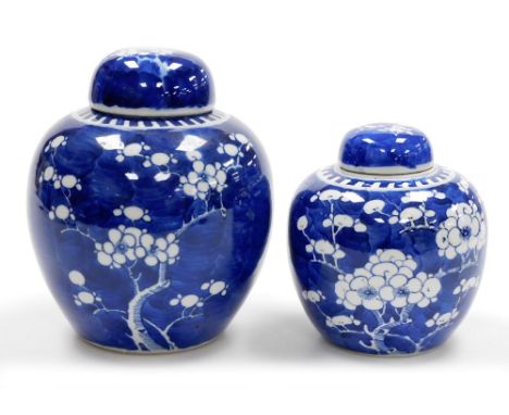 Two Chinese porcelain blue and white ginger jars in prunus pattern, one with four character Kangxi mark to base, 20cm high an