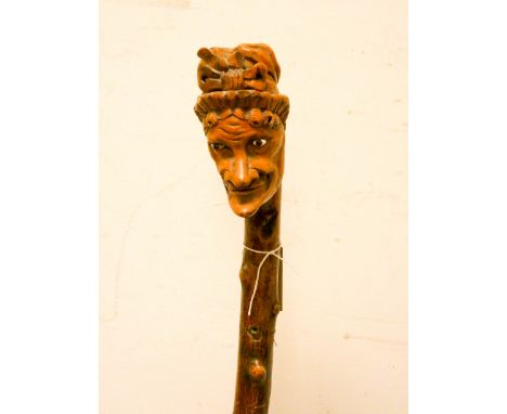 A collectable walking stick -  the top carved with Mrs Punch, on a knobbly cane