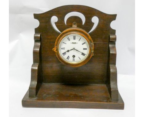 Circular oak cased clock fitted to an oak wall bracket 12" wide 